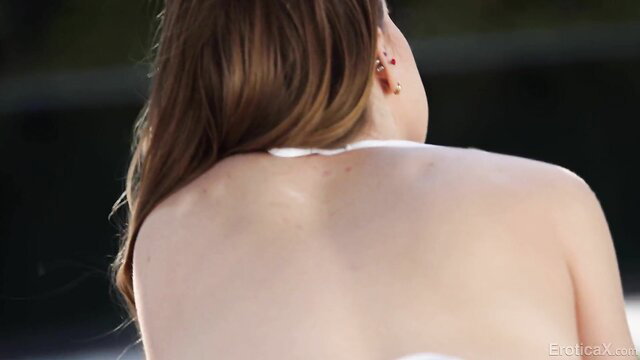 Octavia Red topless back view in white bikini on vacation