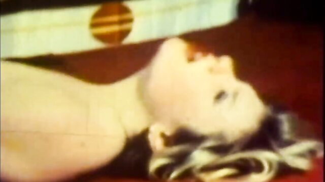 Blonde woman lying nude on floor in provocative pose