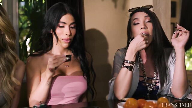 Avery Lust and Jade Venus eating fruit in sexy dresses at MILF Oasis