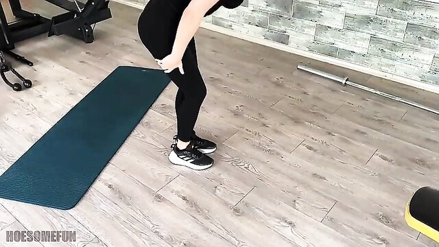 Busty brunette bends over in tight leggings at gym, teasing curves