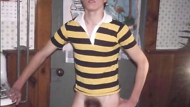 Retro young twink in yellow black polo shirt poses nude with pubes exposed