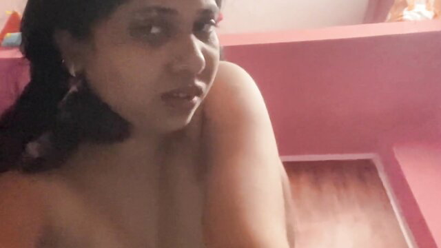 Desi teen with huge tits topless in pink room, seductive gaze