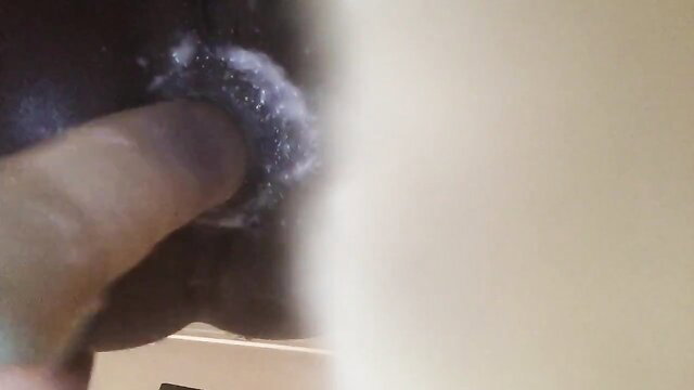Closeup of thick black finger in tight hole with creamy cum dripping out