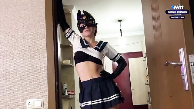 Kinky nymph in sexy sailor schoolgirl costume with mask posing seductively