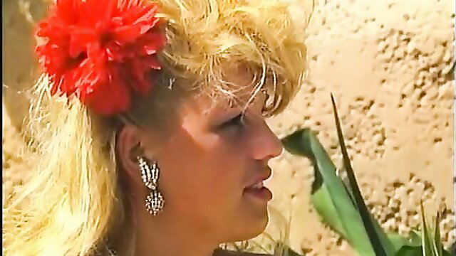 Blonde 80s bombshell with red flower hair, profile in classic 1987 porn