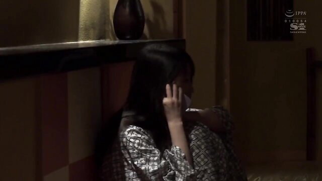 Sad Asian JAV girl in patterned blouse crying on floor with boss