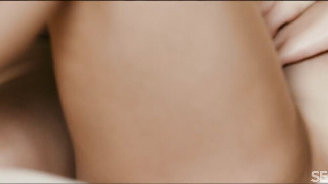 Angelika Grays and Lily Blossom nude embrace, sensual lesbian tease