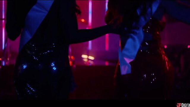 King Noire controls sultry beauty in sparkling dress at neon party