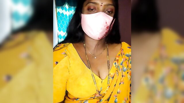 Vani-09 hot Indian MILF in yellow saree, pink mask, deep cleavage tease