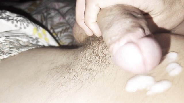 Man's hand stroking huge thick cock with giant balls and massive cum load