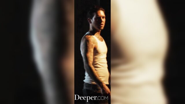 Small Hands in tight tank top, tattooed arms, intense gaze