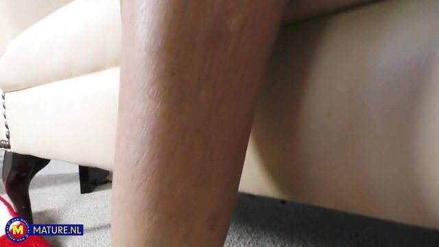 Hot blonde MILF Eva Strong legs spread on couch with red heels solo toy tease