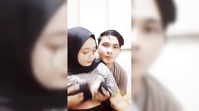Indo hijab girl Diah Asnawi embraces man, cleavage tease