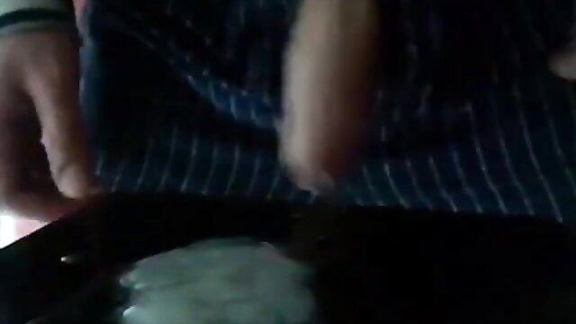 Amateur guy stroking thick cock with pleasure gel on black surface