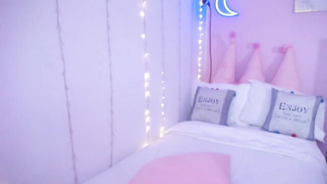 Cute fairy bedroom with pink pillows and moon lights