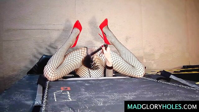 Bound fishnet girl in red heels spreads legs for vagina torture