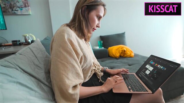 Blonde stepmom typing on laptop in beige top, stepson taboo tease