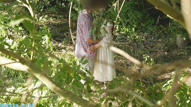 Secret forest rendezvous: lovers embrace passionately in lush woods
