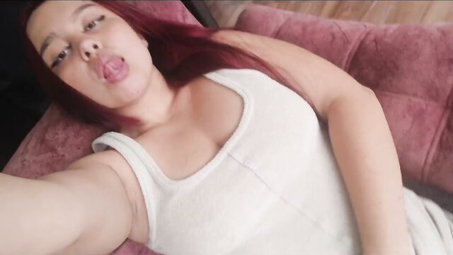 Estherr19 sticks out tongue topless on couch, red hair beauty teases