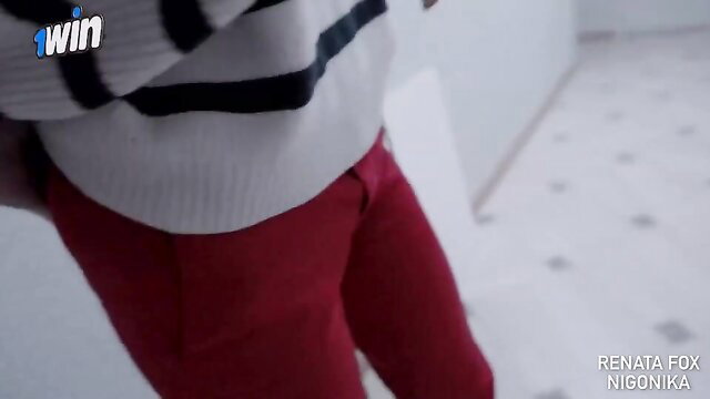 Renata Fox in tight red pants and striped sweater, sexy tease