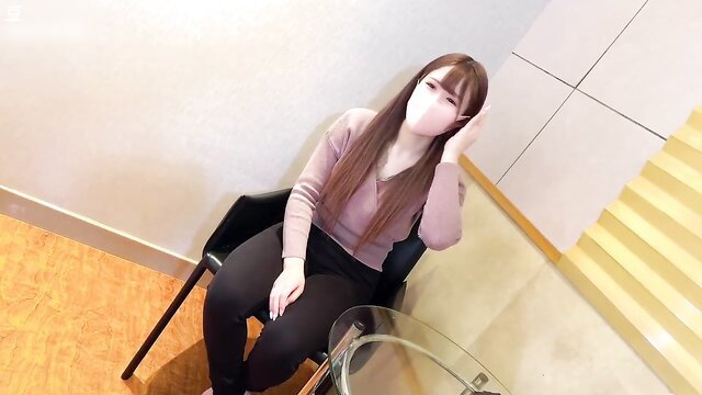 Asian amateur girl in mask and tight pants sits seductively