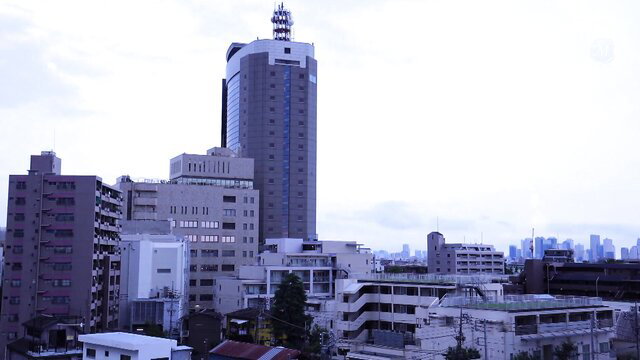 Tokyo skyline cityscape at dusk with tall buildings and clouds