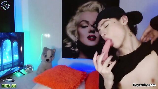 Cute sexy twink sucks pink dildo on cam with hat and nails