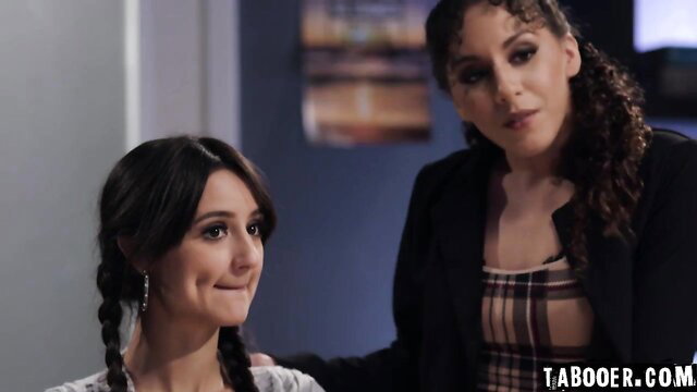 Curly-haired brunette in plaid top touches pigtail girl's face intimately