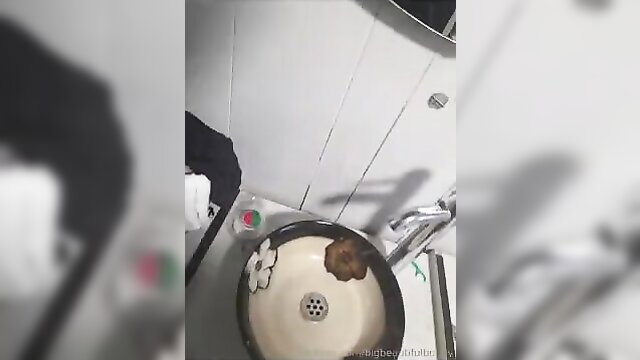 Woman defecating in a toilet