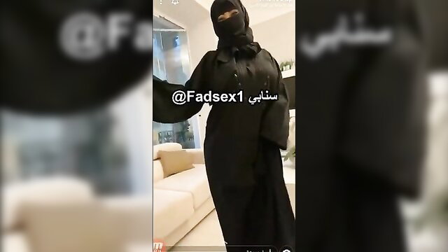 Arab woman in black niqab abaya posing seductively