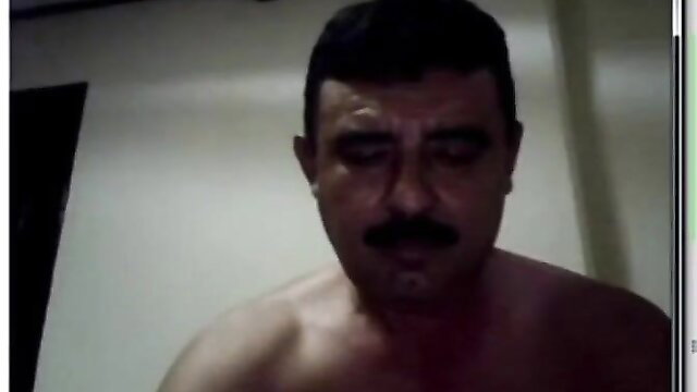 Mature hairy Latino bear with mustache, shirtless closeup