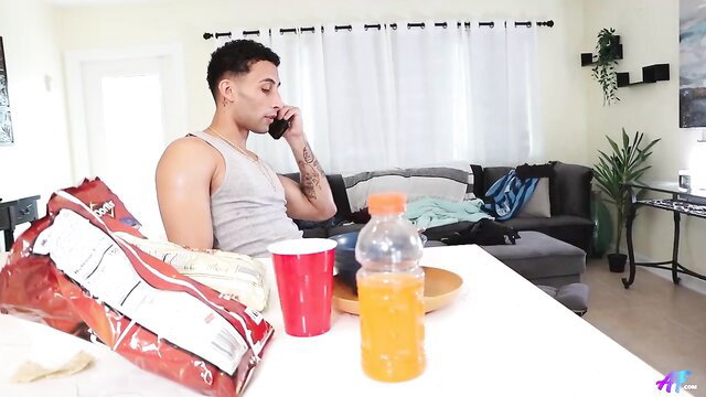 Stevie Bangs on phone, muscular tattooed body in tank top