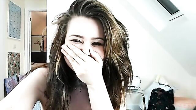 Smiling brunette BBW teen covering mouth laughing topless selfie