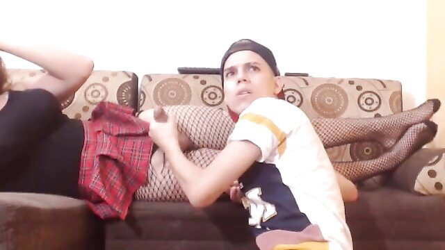 Tgurl in stockings gets handjob from guy, legs spread on couch