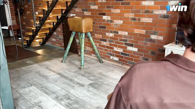 Charming MILF poses by leather pommel horse in sexy room