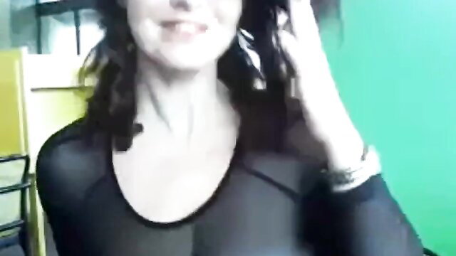 Curvaceous brunette webcam model smiles in sheer mesh top