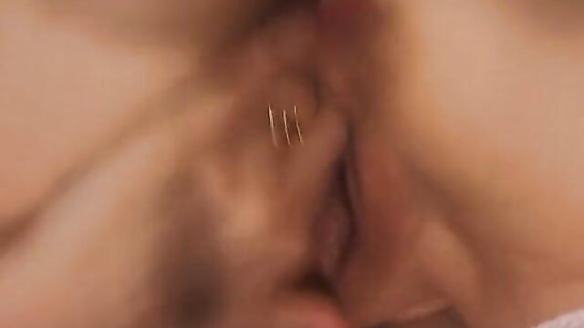 Closeup of mature woman's wet pussy with gold piercings in hardcore fisting scene