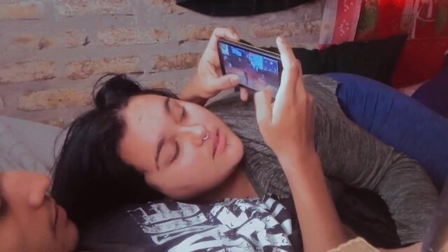 Latina gamer girl on phone gets distracted by blowjob in bed