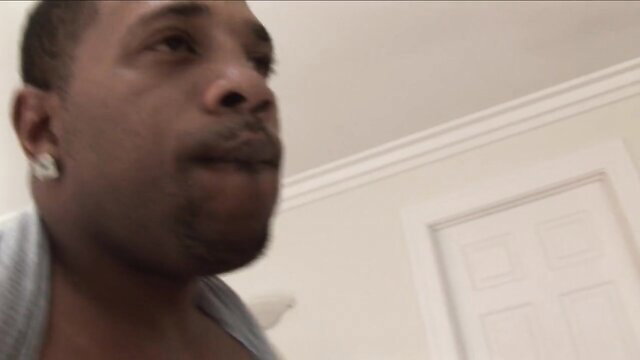 Closeup of handsome black man with earrings smirking in PervMilfsnTeens