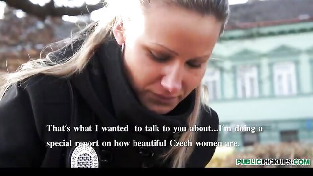 Blonde Czech beauty in black coat discusses pickup on public street