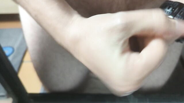 Close-up male hand stroking cock, squirting cum and piss finish