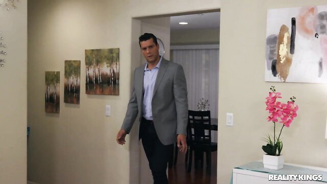 Izzy Lush with handsome suited man entering bedroom doorway