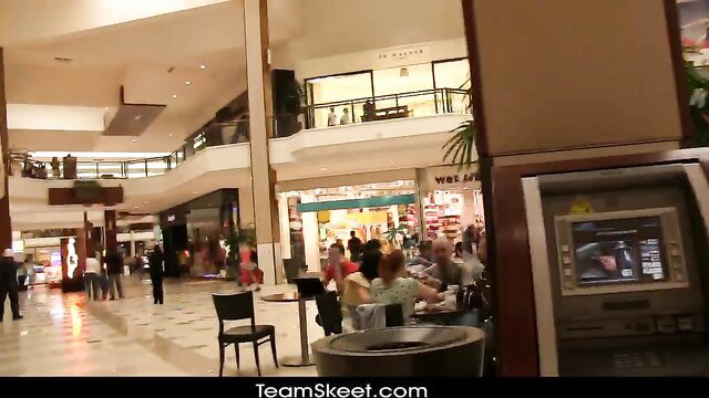 Crowded mall pickup spot with ATM, tables, diverse shoppers