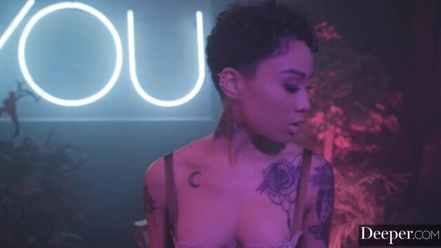 Honey Gold topless tattooed Asian beauty in neon lit tease