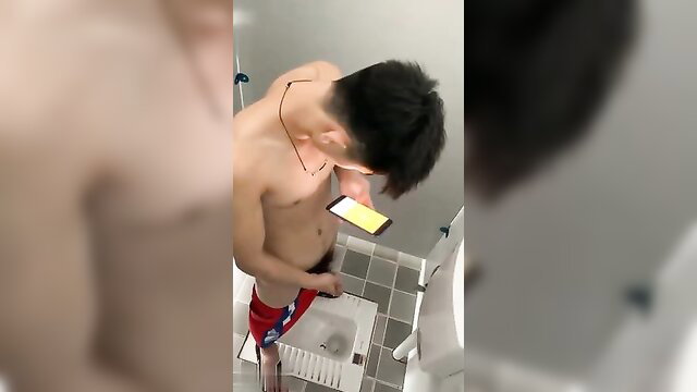 Chinese boy in red speedo pulling down shorts in bathroom voyeur