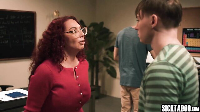 Redhead big tits teacher talks to two students in classroom