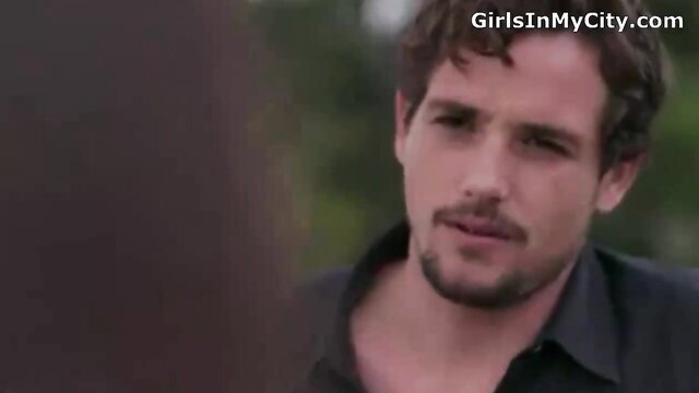 Handsome brunette man in sensual outdoor closeup gaze