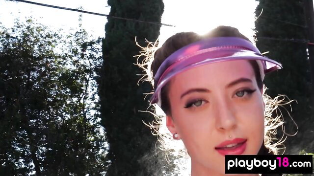 Petite naked babe with pink visor cooling off outdoors