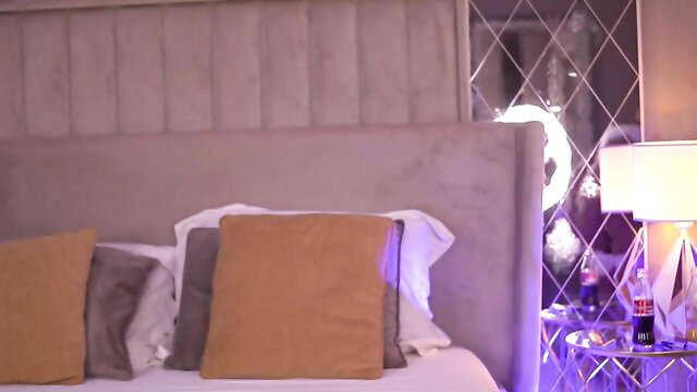 Busty blonde MILF teases fit body in sexy lingerie on bed