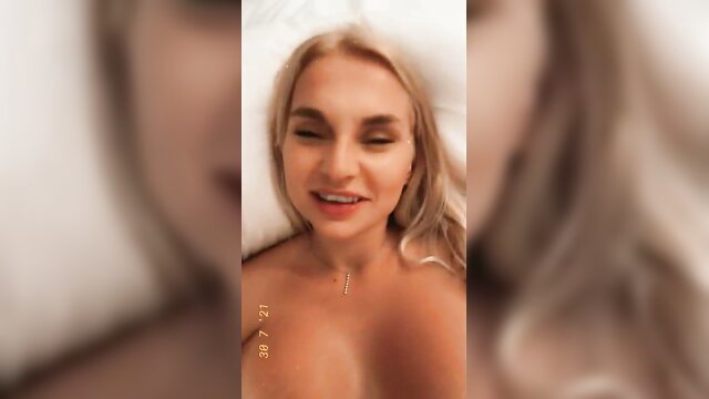 Zoie Burgher nude blonde smiling in bed, big tits exposed